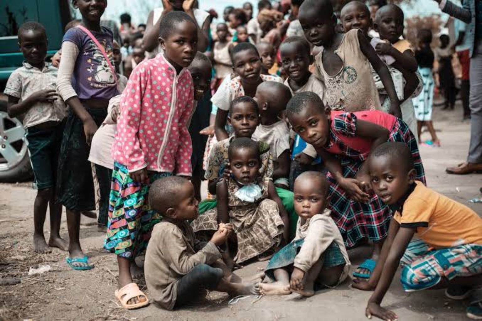 A group of children gathered together in their community