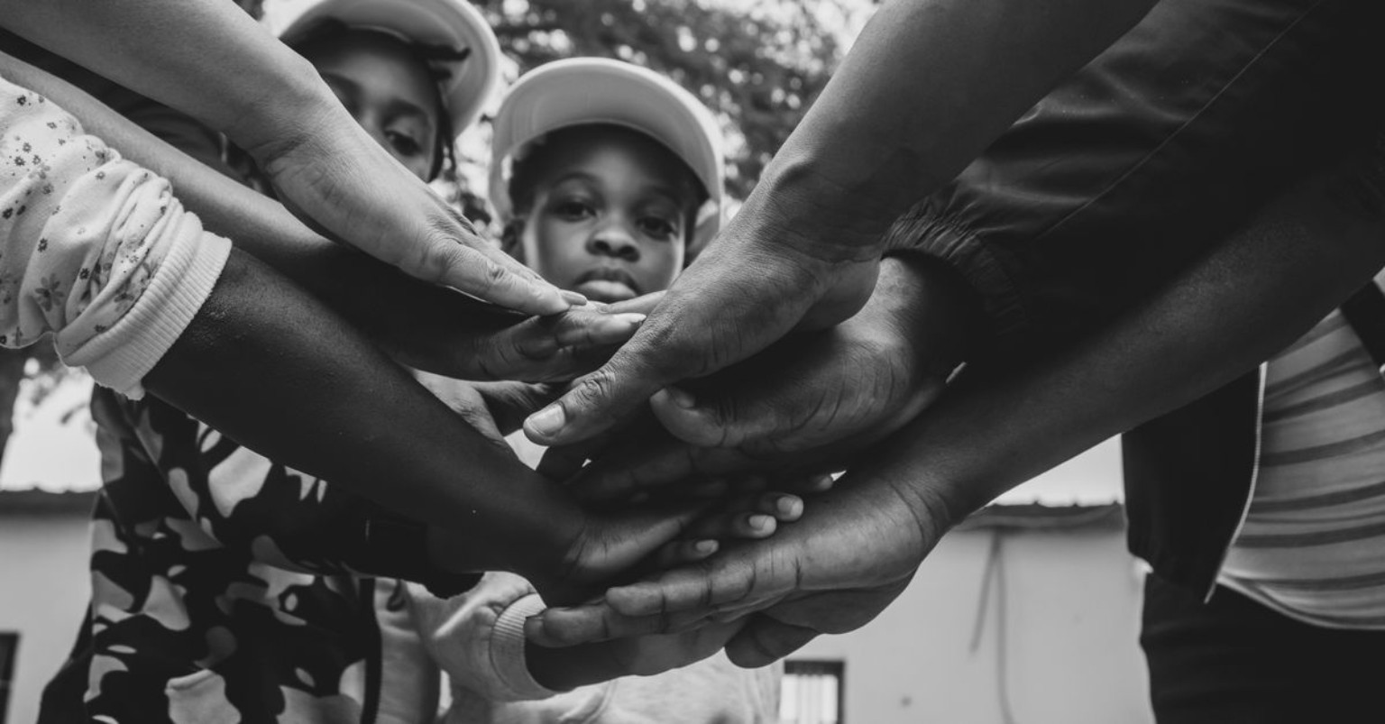 Hands joined together to represent teamwork and solidarity
